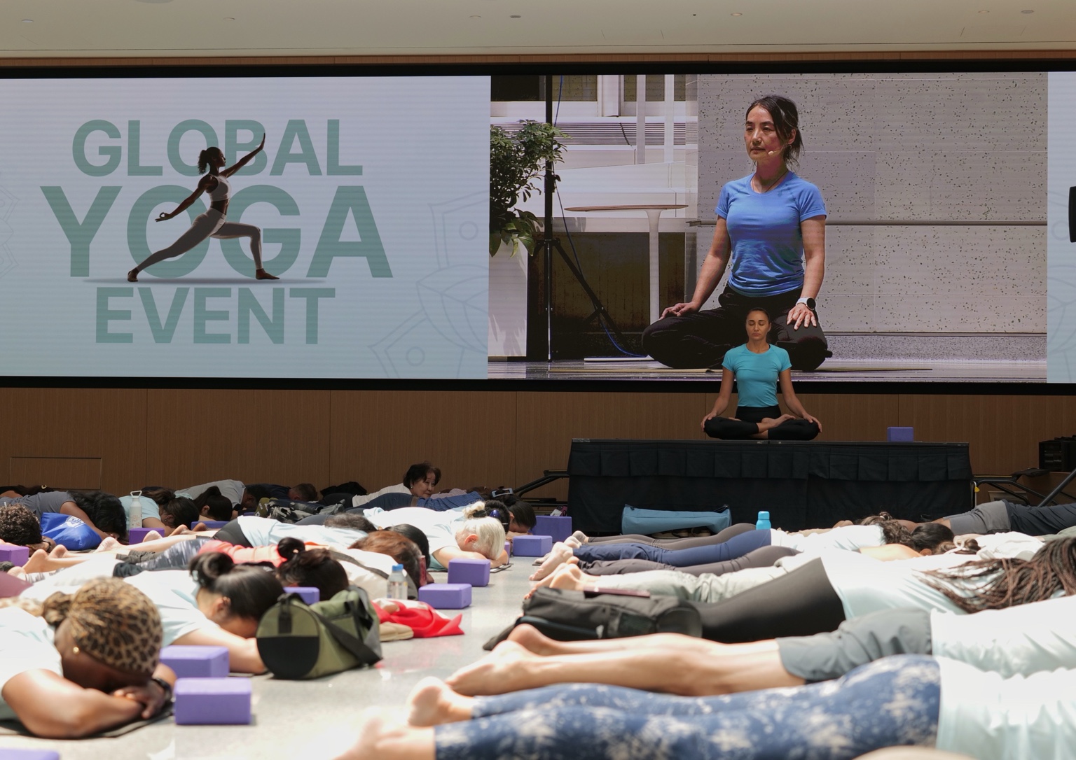 Kseniya leading yoga for a large professional community event