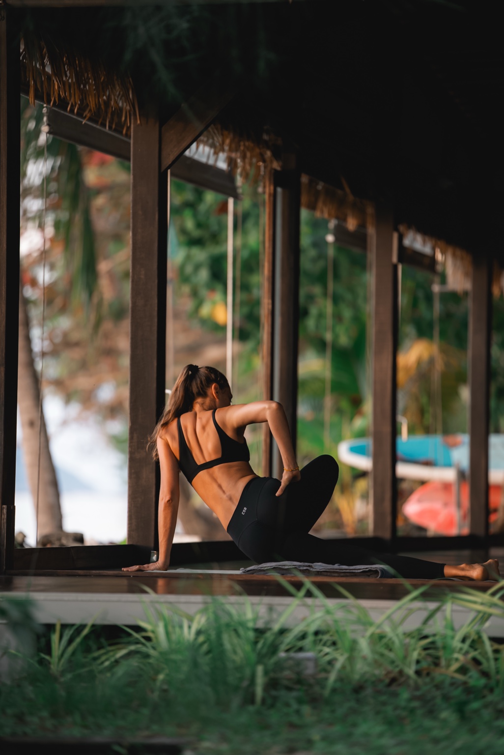 Kseniya practicing yoga surrounded by tropical nature
